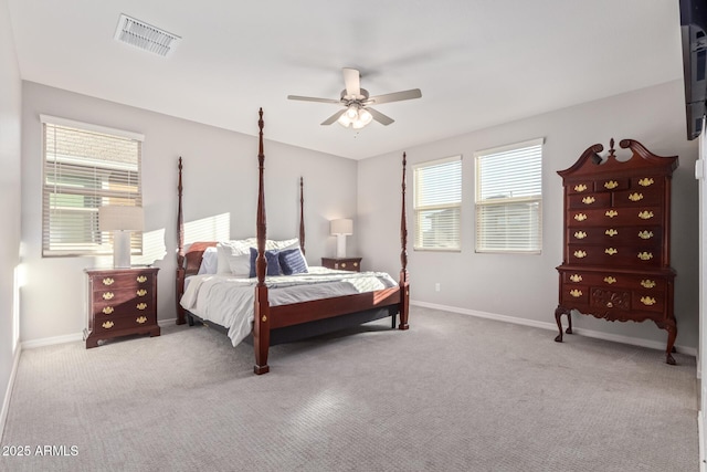 carpeted bedroom with baseboards, visible vents, and a ceiling fan