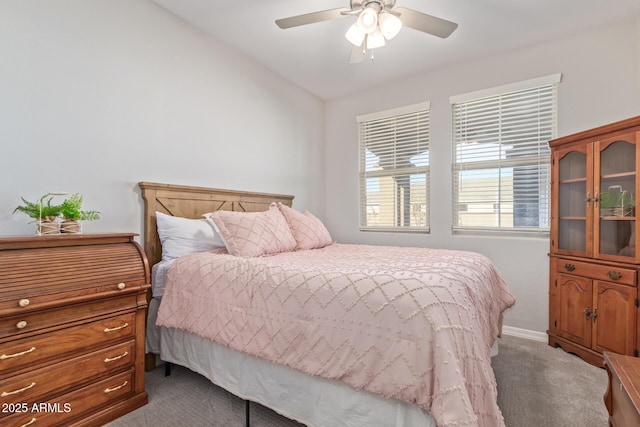 bedroom featuring ceiling fan, vaulted ceiling, baseboards, and dark colored carpet