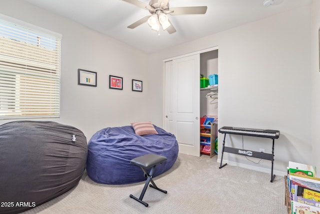 carpeted bedroom featuring a closet, a ceiling fan, and baseboards