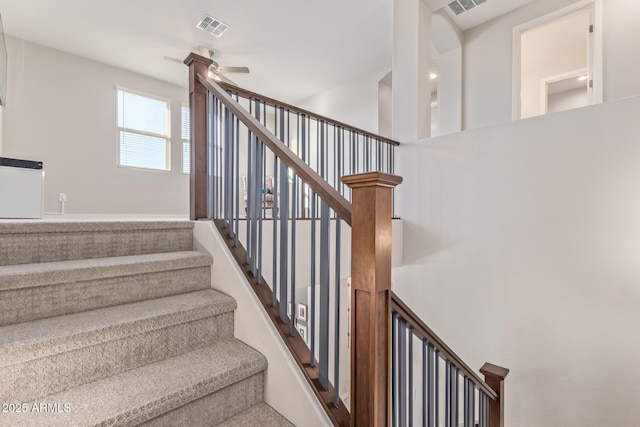 stairs featuring visible vents and a ceiling fan