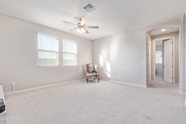 unfurnished room with carpet, baseboards, visible vents, and ceiling fan