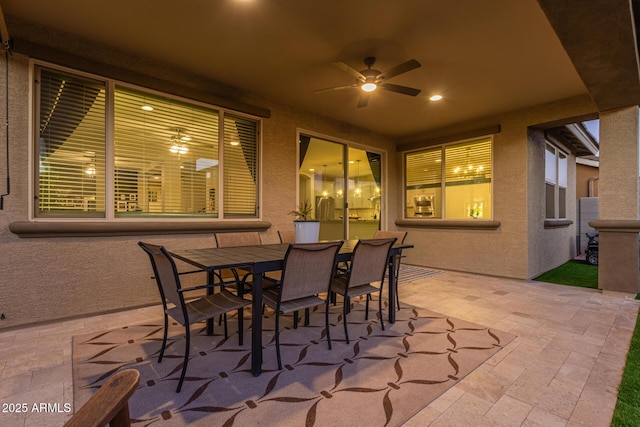 view of patio with a ceiling fan and outdoor dining space