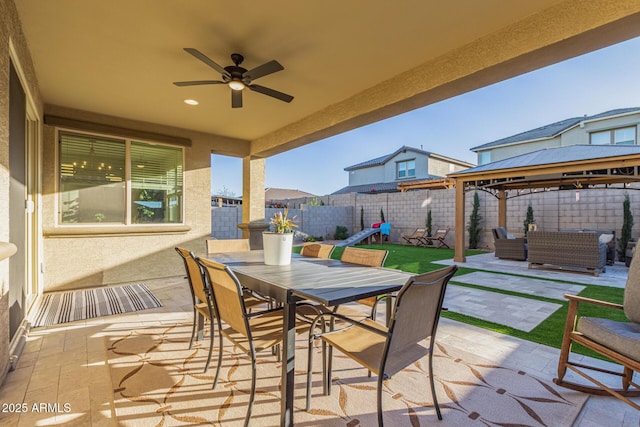 view of patio featuring ceiling fan, outdoor dining area, a fenced backyard, outdoor lounge area, and a gazebo