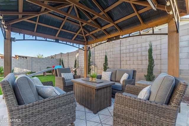 view of patio with a fenced backyard, outdoor lounge area, and a gazebo