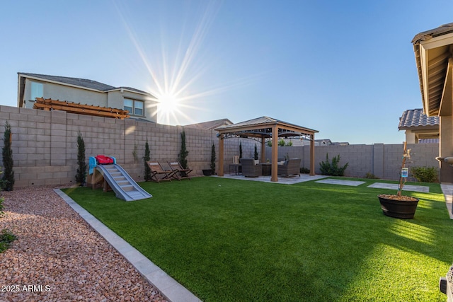 view of yard featuring a patio area, a fenced backyard, and a gazebo