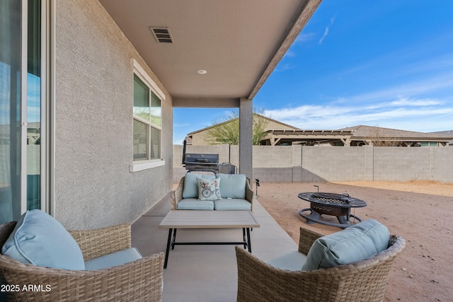 view of patio / terrace with a grill and an outdoor living space with a fire pit