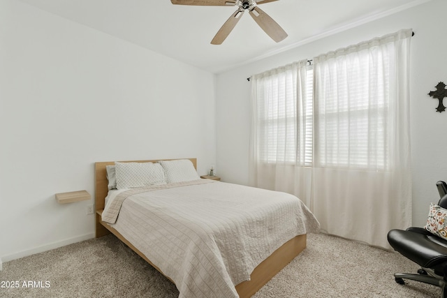 bedroom with ceiling fan, light carpet, and multiple windows