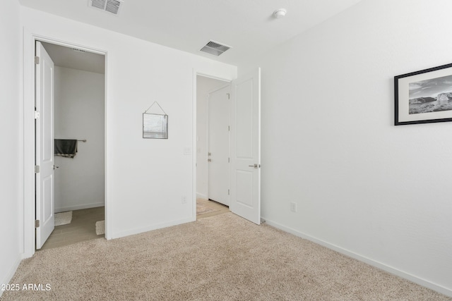 unfurnished bedroom featuring light carpet