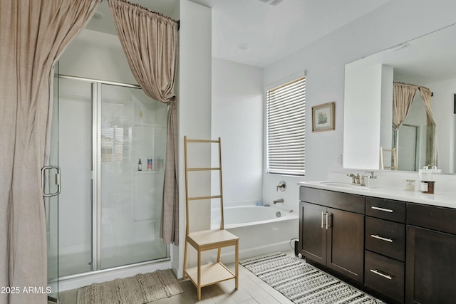 bathroom featuring vanity and shower with separate bathtub