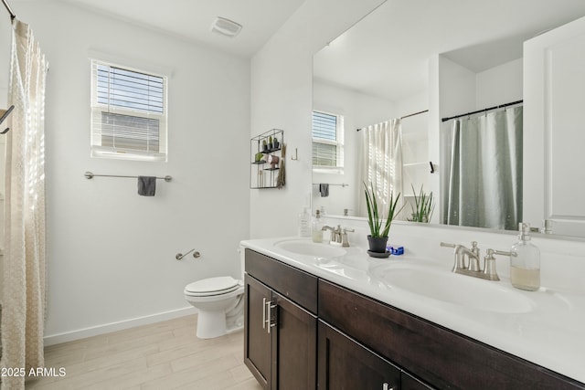 bathroom with vanity, wood-type flooring, and toilet