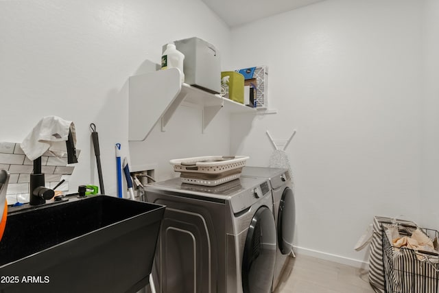 washroom featuring separate washer and dryer and sink