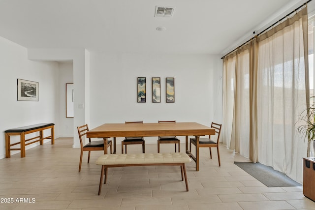 dining space with light hardwood / wood-style flooring