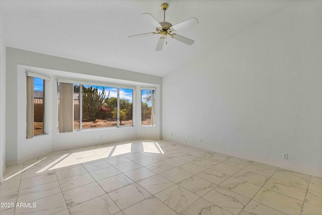 empty room featuring high vaulted ceiling, marble finish floor, and ceiling fan