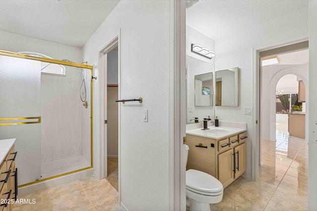 full bath with tile patterned flooring, toilet, a stall shower, and vanity