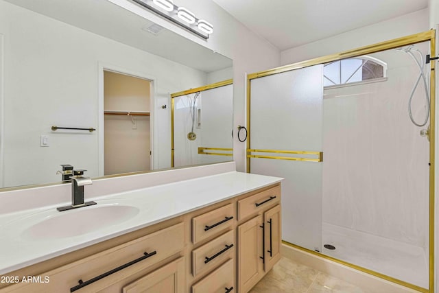 full bath with vanity, a shower stall, visible vents, and tile patterned floors