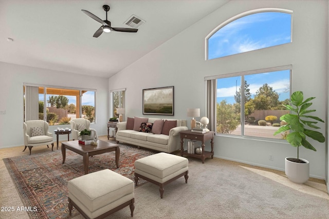 living area featuring visible vents, baseboards, light colored carpet, high vaulted ceiling, and a ceiling fan