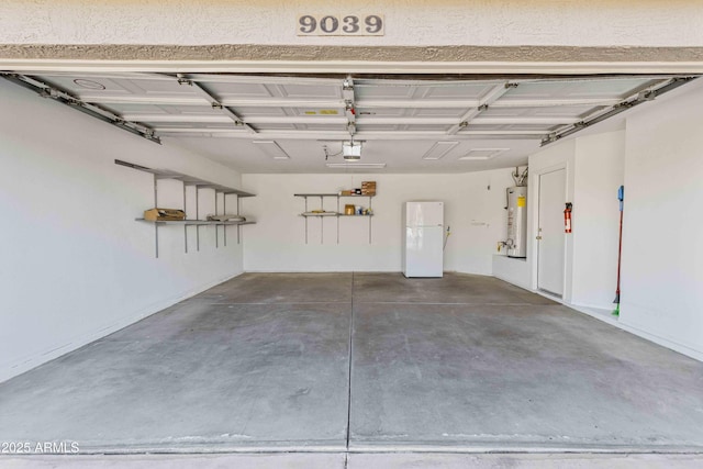 garage featuring gas water heater, a garage door opener, and freestanding refrigerator