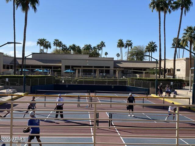 view of tennis court featuring fence