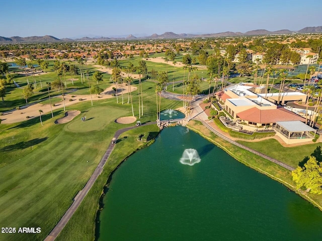 drone / aerial view with golf course view and a water and mountain view