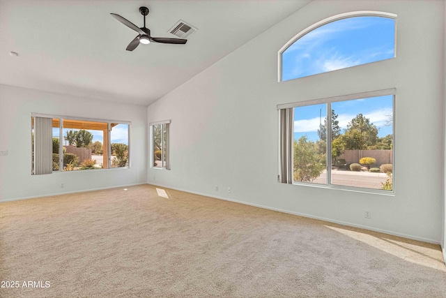 carpeted spare room with visible vents, baseboards, high vaulted ceiling, and ceiling fan