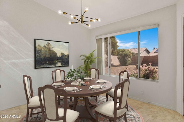 dining area featuring light tile patterned flooring, plenty of natural light, and a chandelier