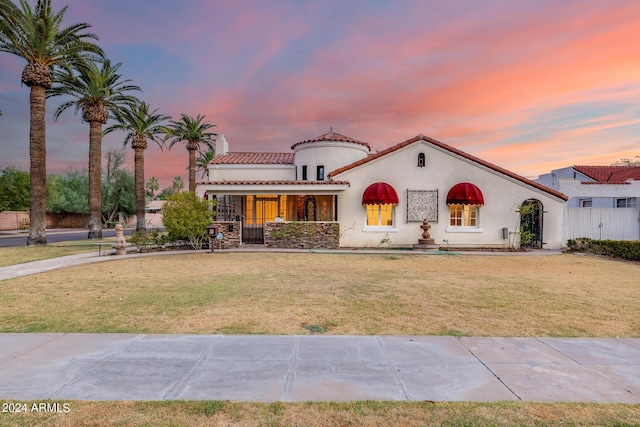 mediterranean / spanish-style home with a lawn