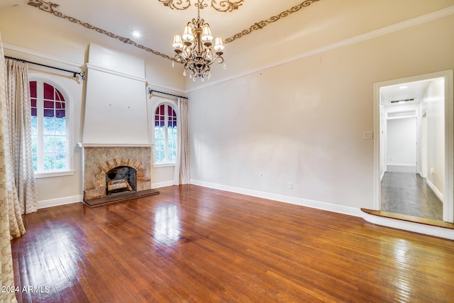 unfurnished living room featuring ornamental molding, wood-type flooring, and a notable chandelier