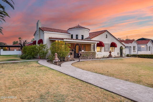 mediterranean / spanish-style house featuring a lawn