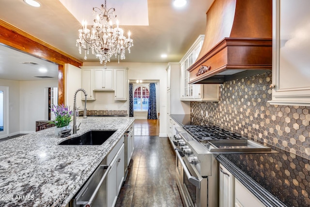 kitchen with white cabinetry, sink, stainless steel appliances, dark hardwood / wood-style flooring, and premium range hood