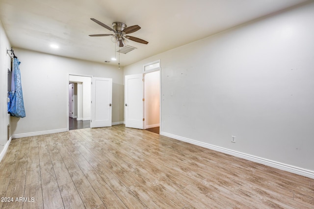 unfurnished room with light wood-type flooring and ceiling fan