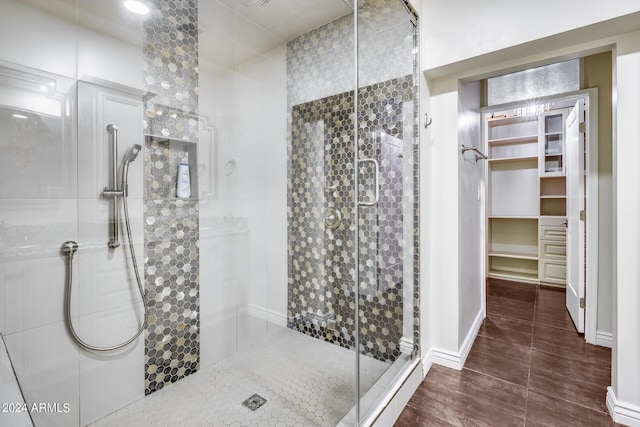 bathroom with wood-type flooring and walk in shower