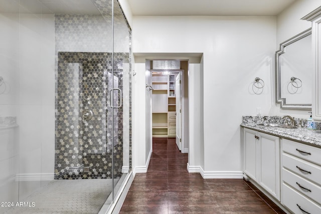 bathroom with vanity, an enclosed shower, and wood-type flooring