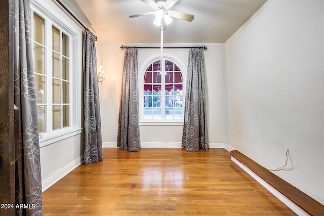 empty room featuring hardwood / wood-style floors and ceiling fan