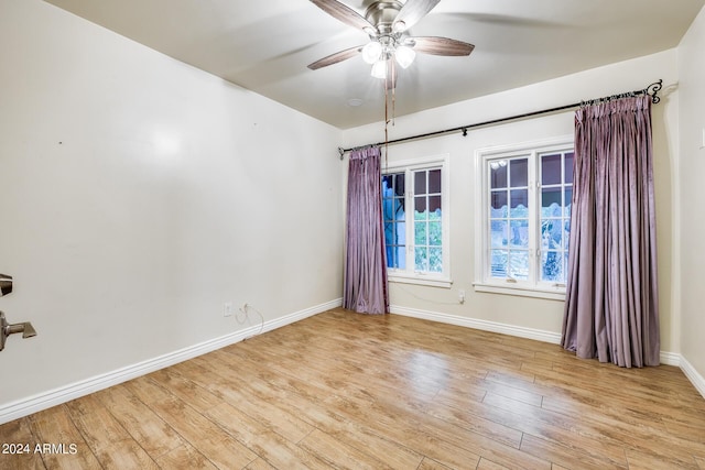 spare room featuring ceiling fan and light hardwood / wood-style flooring