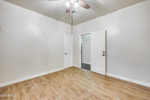 spare room featuring light hardwood / wood-style floors and ceiling fan