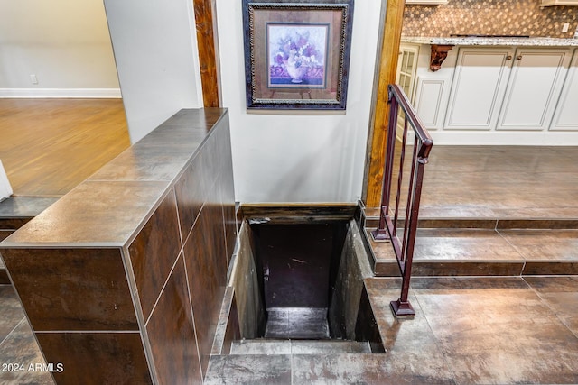 stairs featuring hardwood / wood-style floors