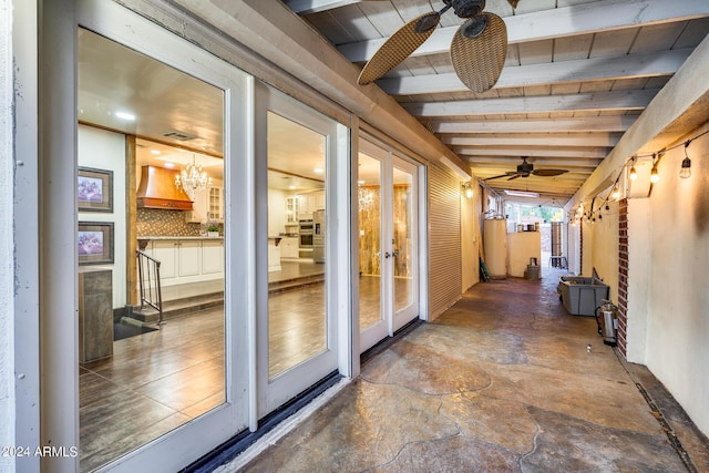 hallway with french doors and vaulted ceiling with beams