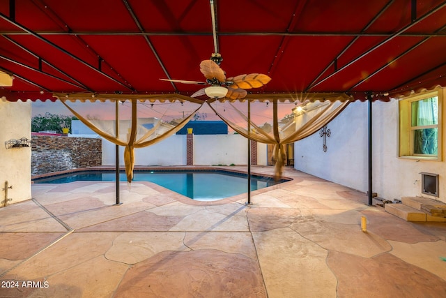 view of swimming pool with ceiling fan and a patio