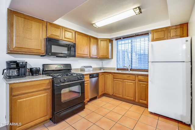 kitchen with black appliances, a raised ceiling, light tile patterned floors, and sink