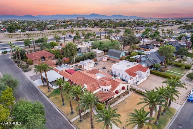 aerial view at dusk featuring a mountain view