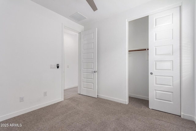 unfurnished bedroom featuring a closet, carpet flooring, visible vents, and baseboards