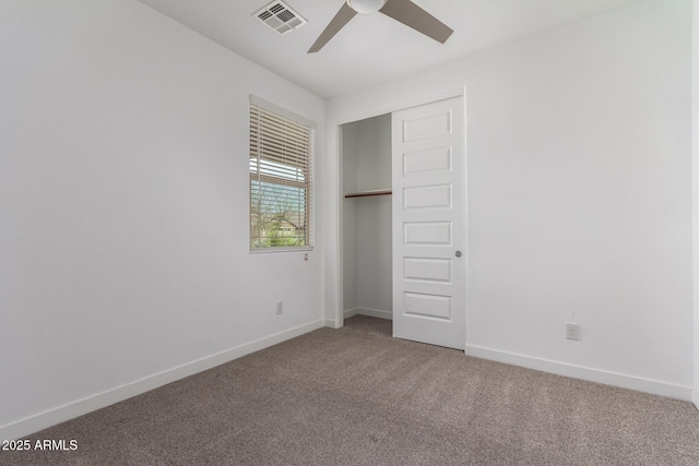 unfurnished bedroom featuring carpet floors, a closet, visible vents, and baseboards