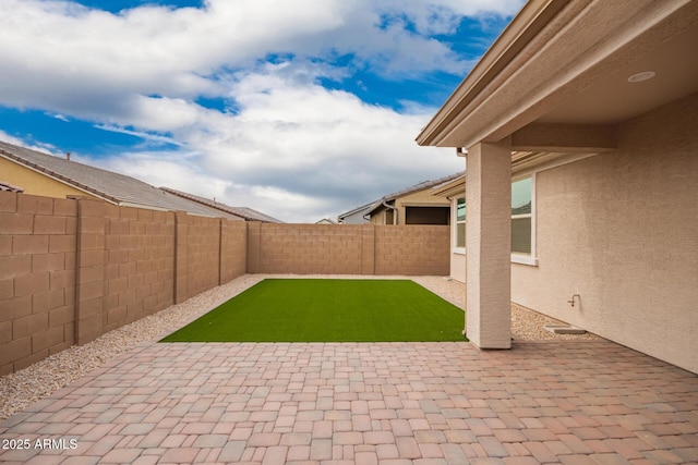 view of yard featuring a patio area and a fenced backyard