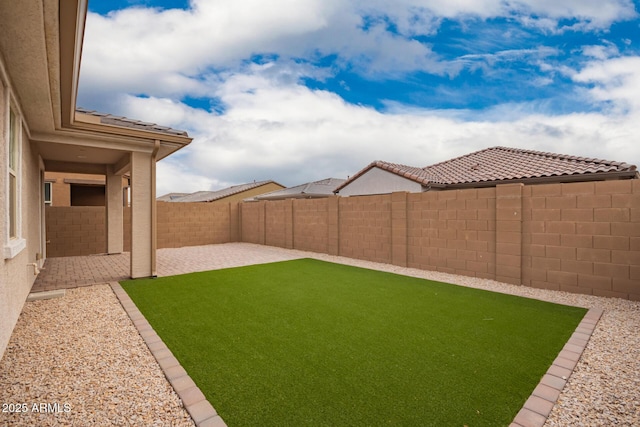 view of yard with a fenced backyard and a patio