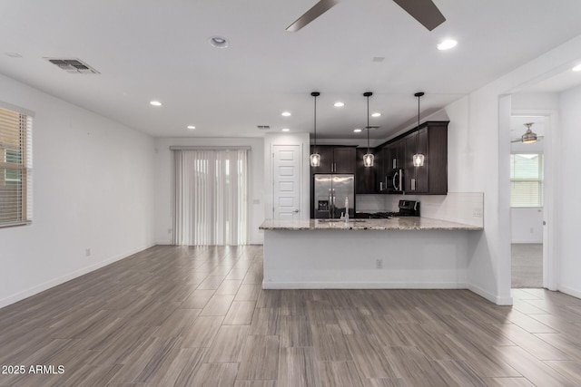 kitchen with ceiling fan, dark brown cabinetry, a peninsula, visible vents, and appliances with stainless steel finishes