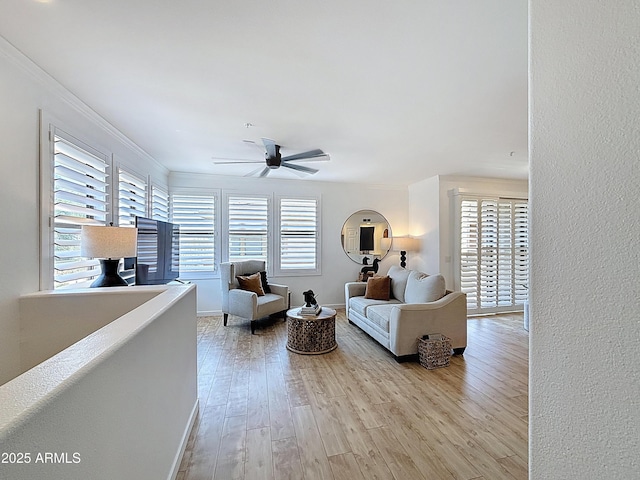 19777 N 76th St N Unit 2243, Scottsdale, AZ 85255 - living area with a ceiling fan, crown molding, wood finished floors, and baseboards
