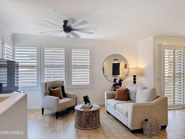 19777 N 76th St N Unit 2243, Scottsdale, AZ 85255 - living area featuring ceiling fan, healthy amount of natural light, wood finished floors, and crown molding