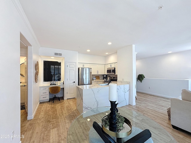 19777 N 76th St N Unit 2243, Scottsdale, AZ 85255 - living area featuring an office area, light wood-style floors, baseboards, recessed lighting, and ornamental molding