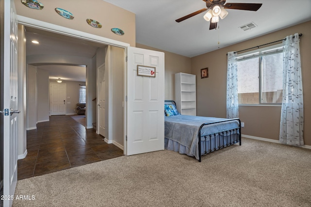 carpeted bedroom with ceiling fan and multiple windows