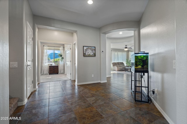 foyer entrance featuring ceiling fan and plenty of natural light